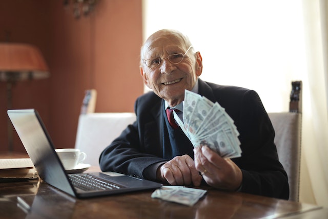 Old man showing his winnings from online casino in San Francisco
